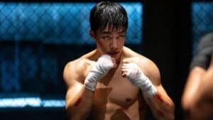 Cena final de Cães de Caça temporada 2 com Gun-woo em confronto intenso