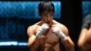 Cena final de Cães de Caça temporada 2 com Gun-woo em confronto intenso